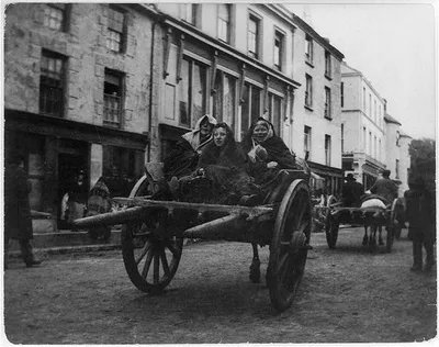 Killarney - [3] Irish women going to a funeral [in a horse-drawn cart], 1899