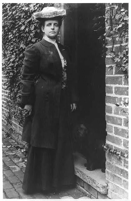 [Frances Benjamin Johnston, in doorway with cocker spaniel]