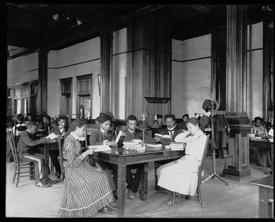 [Interior view of library reading room with male and female students…, Alabama, Tuskegee, 1902