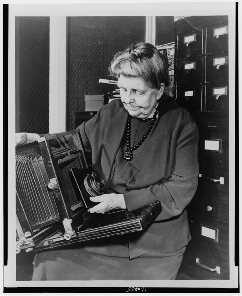[Frances Benjamin Johnston, three-quarter length portrait, holding…, 1950